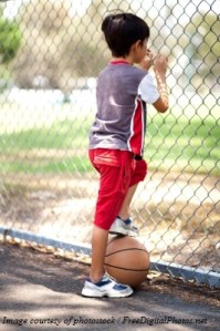 basketball player at a fence